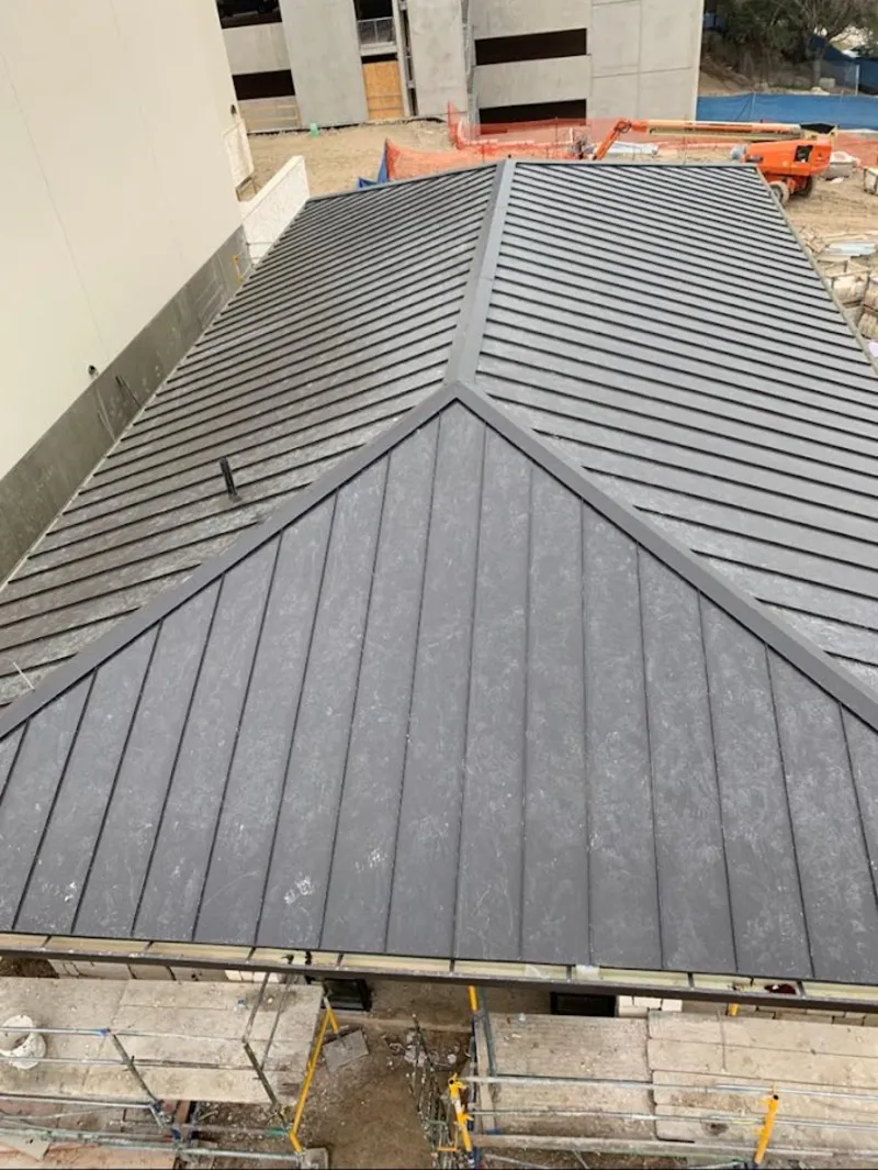 Commercial metal roof construction with crane equipment in North Berwick